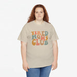 Beige T-shirt met ronde hals en opdruk “Tired Moms Club” op de borst.
