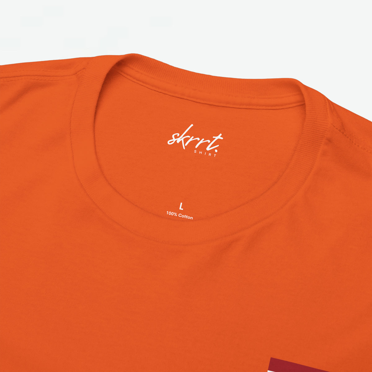 Oranje oversized t-shirtkraag met kleine skrrt-print en 100% cotton tekst