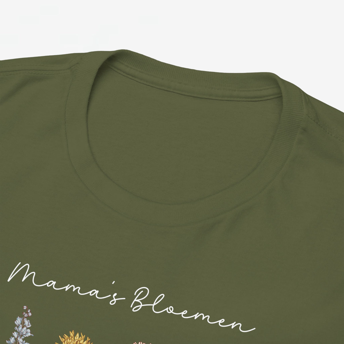 Close-up van legergroene T-shirt met witte siertekst en bloemenprint op de borst