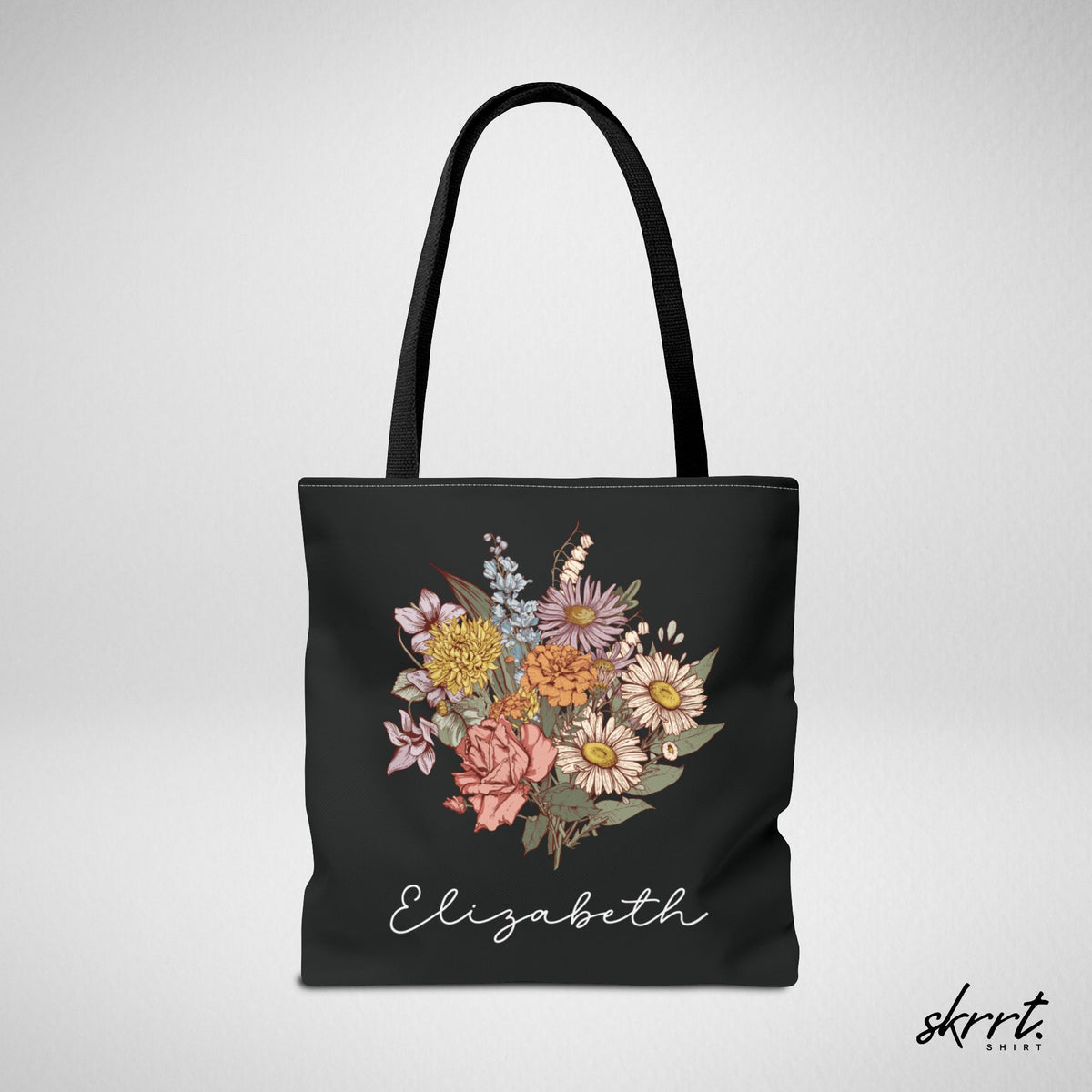 Zwarte tote bag met kleurrijke bloemenprint en naam Elizabeth, grote voorzijde.