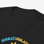 Zwart T-shirt close-up: ronde hals en bovenkant van print met “Overstimulated”