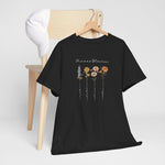 T-shirt zwart met bloemenprint en sierlijke tekst op de borst, aan kledinghanger.
