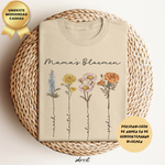 Beige T-shirt met bloemenillustraties en tekst “Mama’s Bloemen” op de borst.